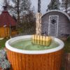 Hot tub in setting with barrel and grill